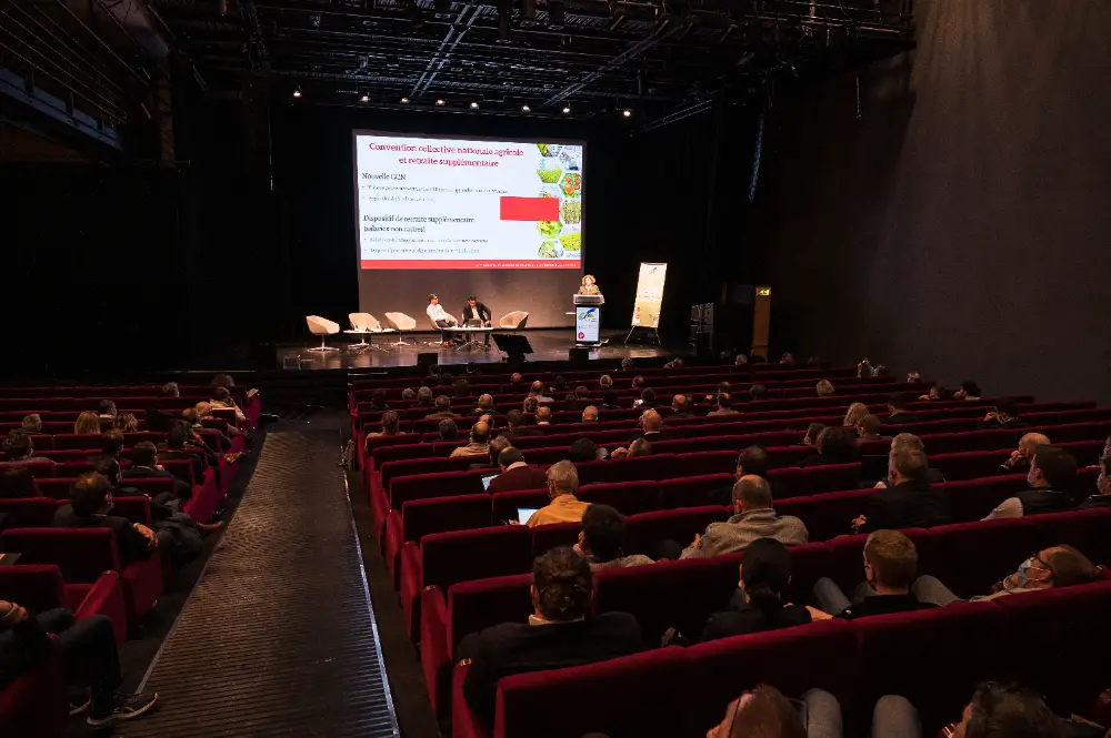 Le public assiste à une présentation projetée sur grand écran dans une salle de congrès à Nantes.